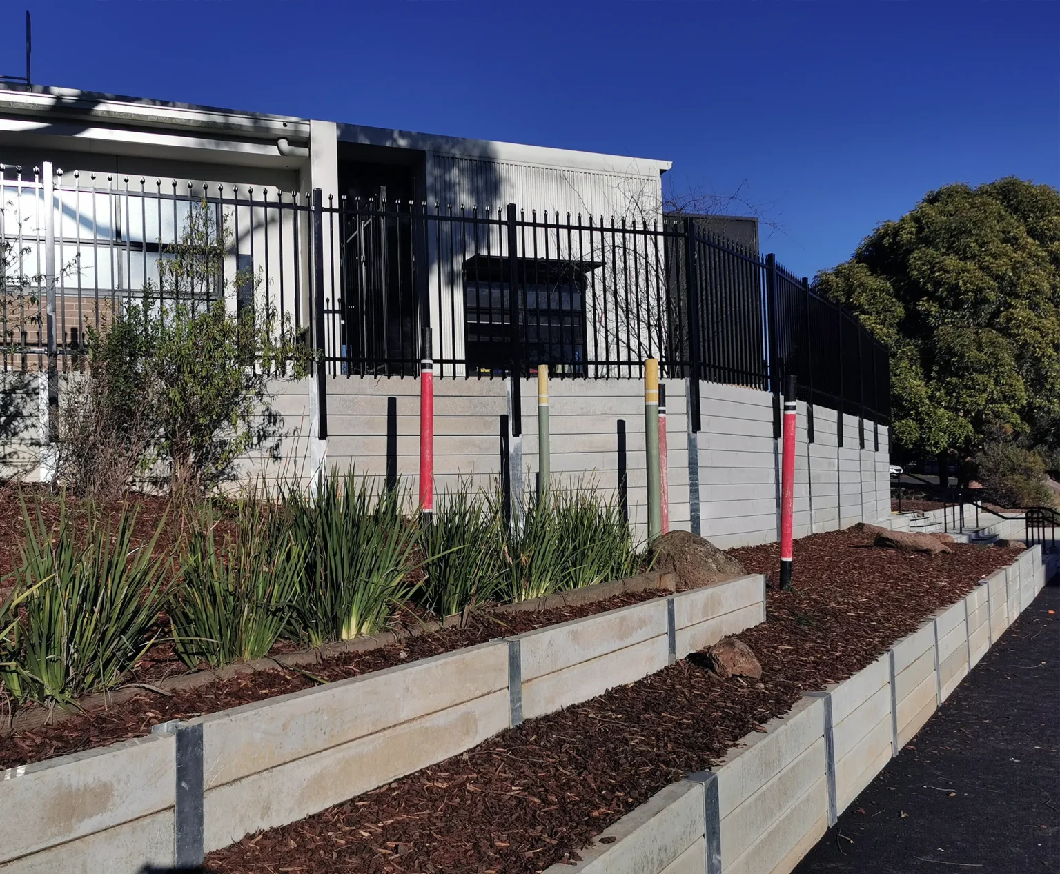 The Marina Smooth Face Concrete Sleeper in Plain Grey Used for a School Retaining Wall Project and Supplied by Sunset Sleepers