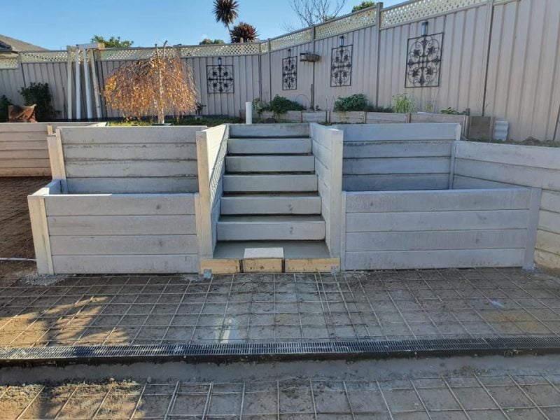 Backyard Steps Retaining Wall Under Construction by Dream View Landscape Plain Grey Marina Smooth Concrete Sleepers and Supplied by Sunset Sleepers